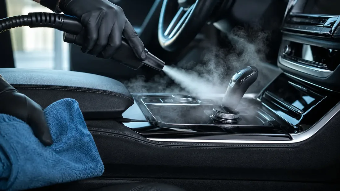 Steam cleaner working a car center console